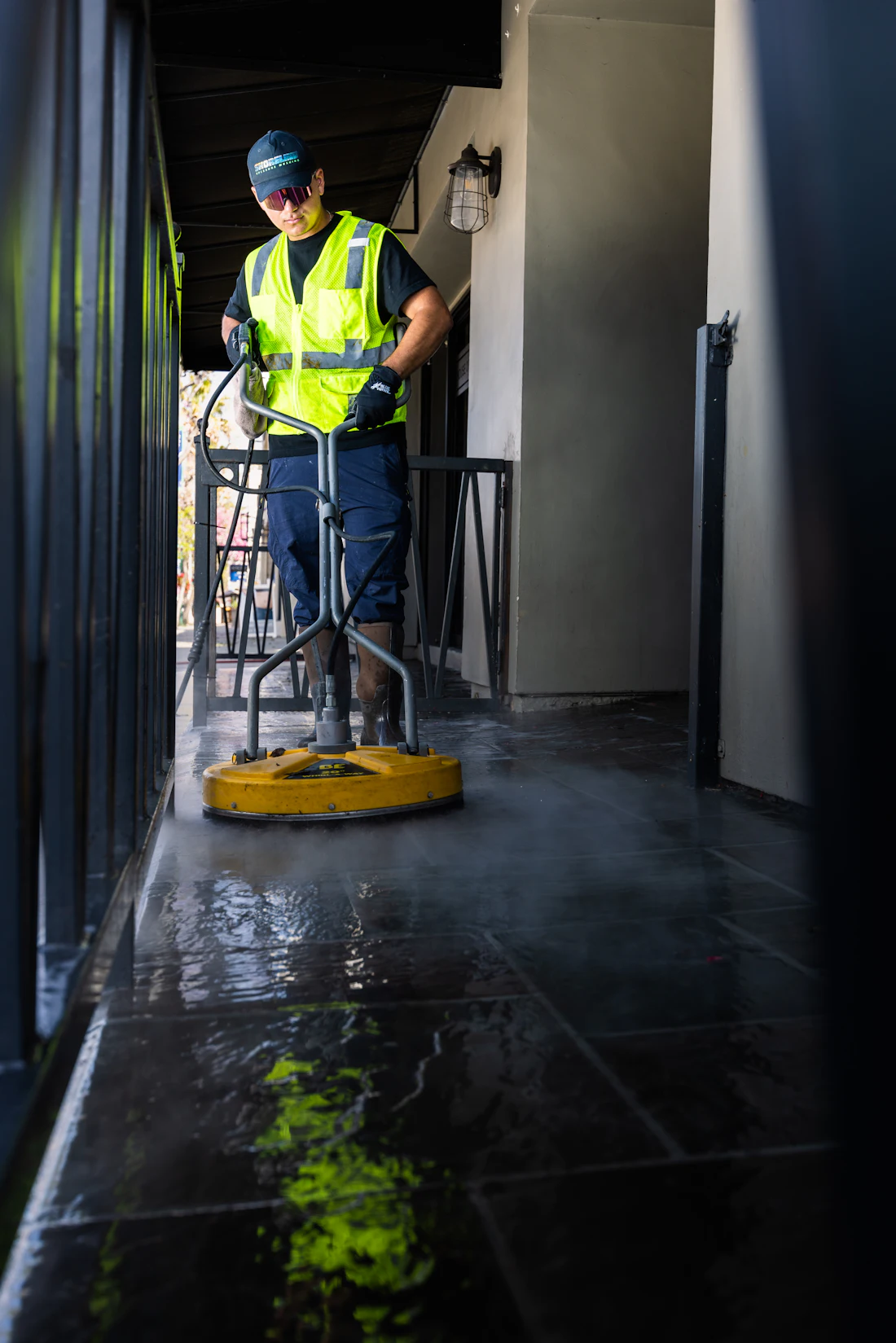 Rotary surface cleaner washing a paved floor